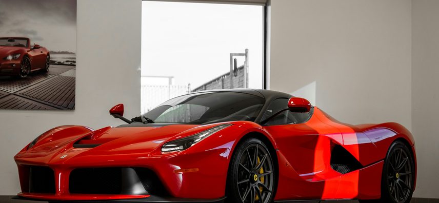 Red Ferrari LaFerrari in a dealership showroom